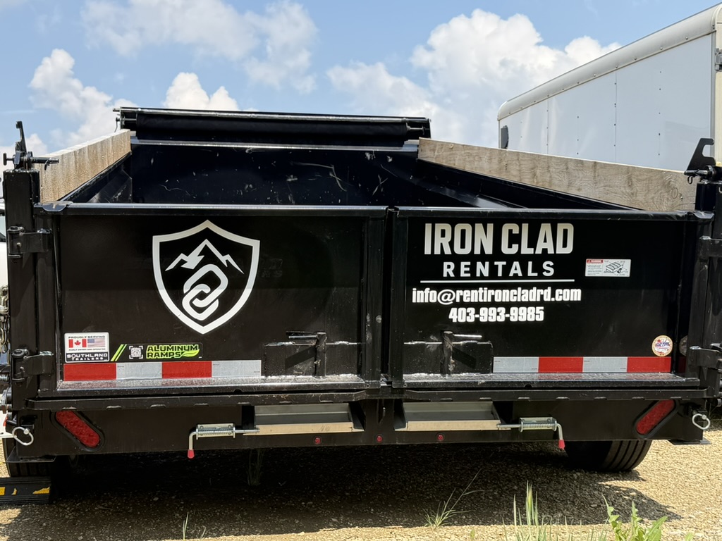 Iron Clad Rentals branded dump trailer rear view